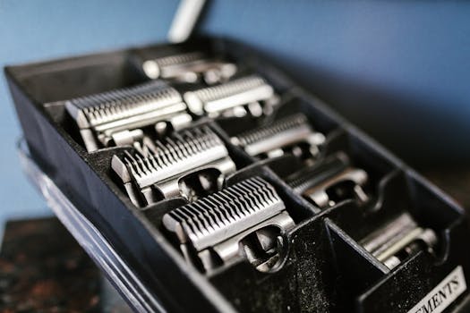 Close-up view of professional barber trimmer attachments neatly arranged in a black box.